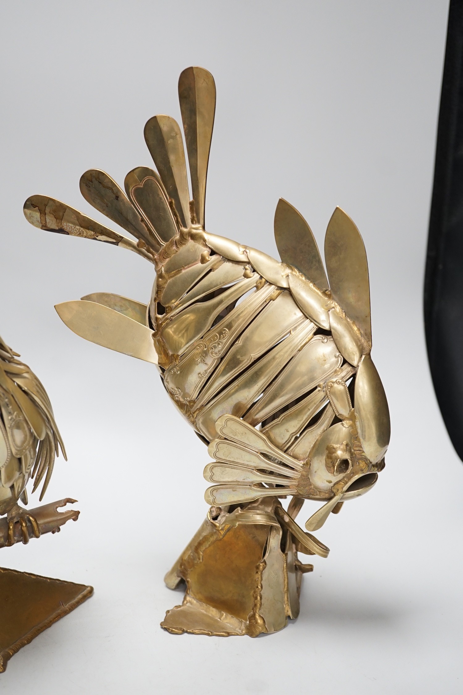 Two stylish nickel ornaments; an owl perching and an exotic fish, constructed from old knives and forks, one indistinctly signed and dated 1990, Tallest 35cm